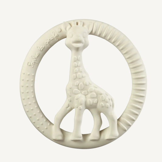 A white natural rubber giraffe-shaped circle teether with raised dot textures and ribbed grip sections around the ring.