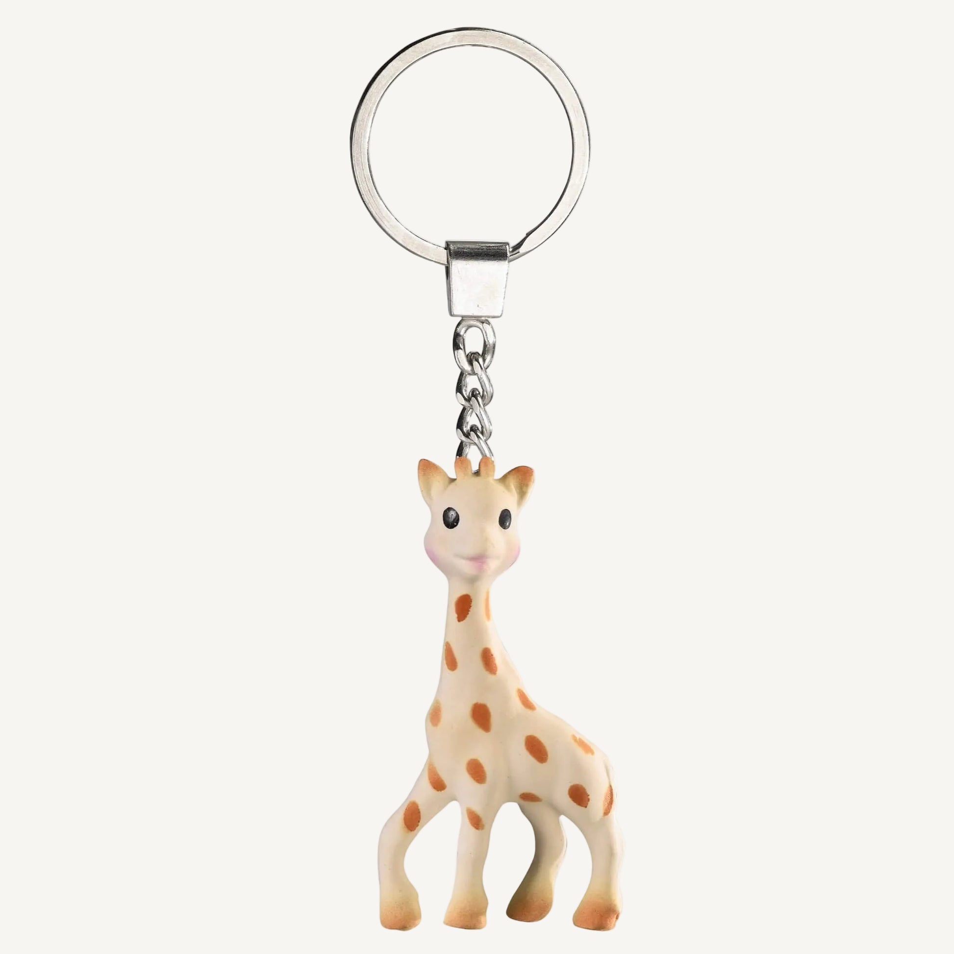 A small giraffe-shaped keyring with brown spotted markings attached to a silver metal keyring on a plain background.