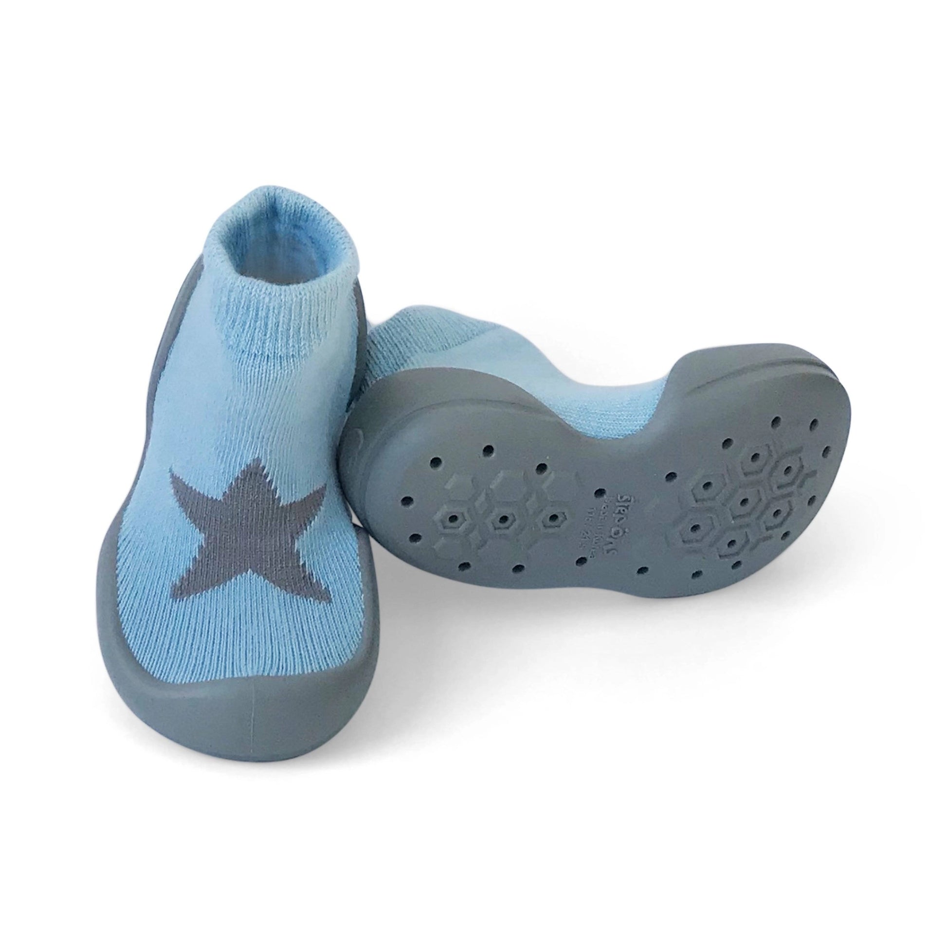 Blue star Step Ons shown from the front and sole, with grey star detail, soft knitted upper and grippy non-slip sole pattern.