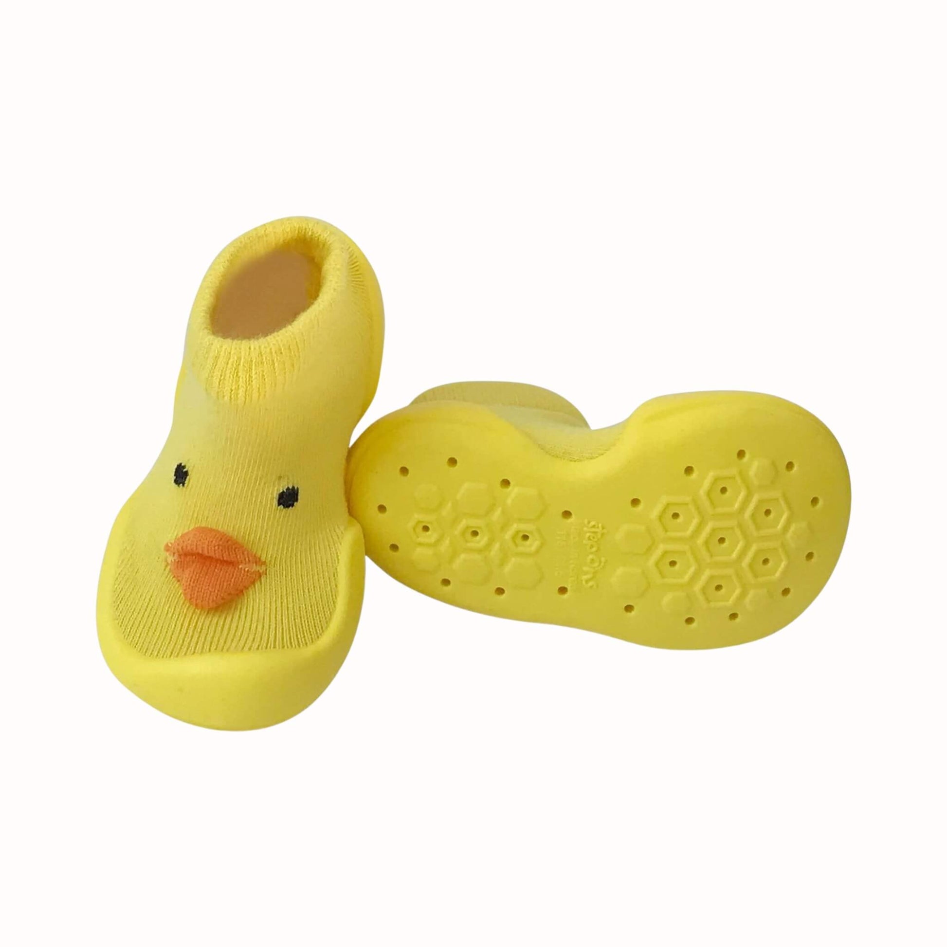 Yellow chick Step Ons shown from the front and sole, with orange beak detail, soft knitted upper and grippy non-slip sole pattern.