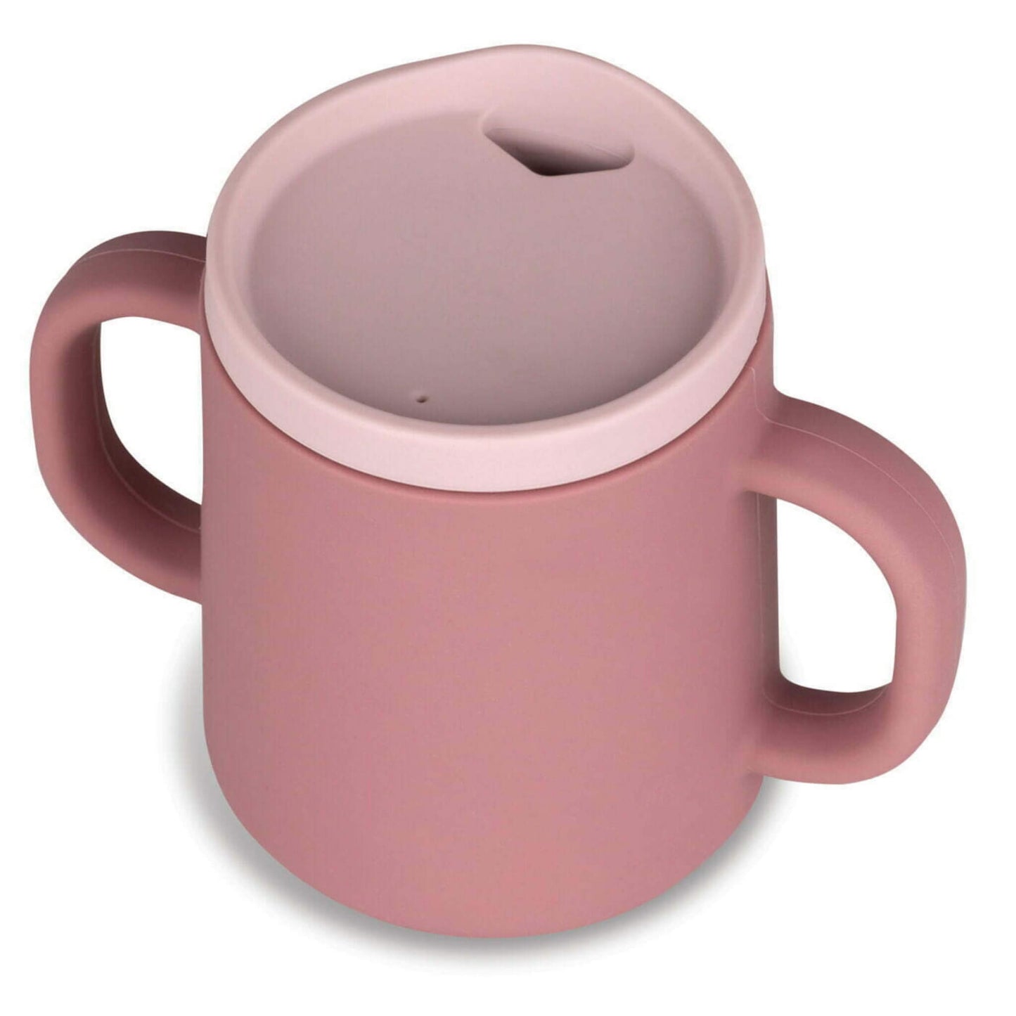 Angled view of a dusty pink silicone trainer cup with two side handles and a recessed rim lid, showing the drinking opening.