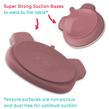 A pink silicone baby feeding set . Image shows a pink bear-shaped plate and snack pot with super strong suction bases for secure placement on tables.