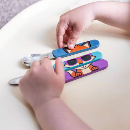 A child arranging a cutlery Set, featuring colourful Felicity Fox handles on the spoon, knife, and fork. Designed for easy self-feeding and creativity.