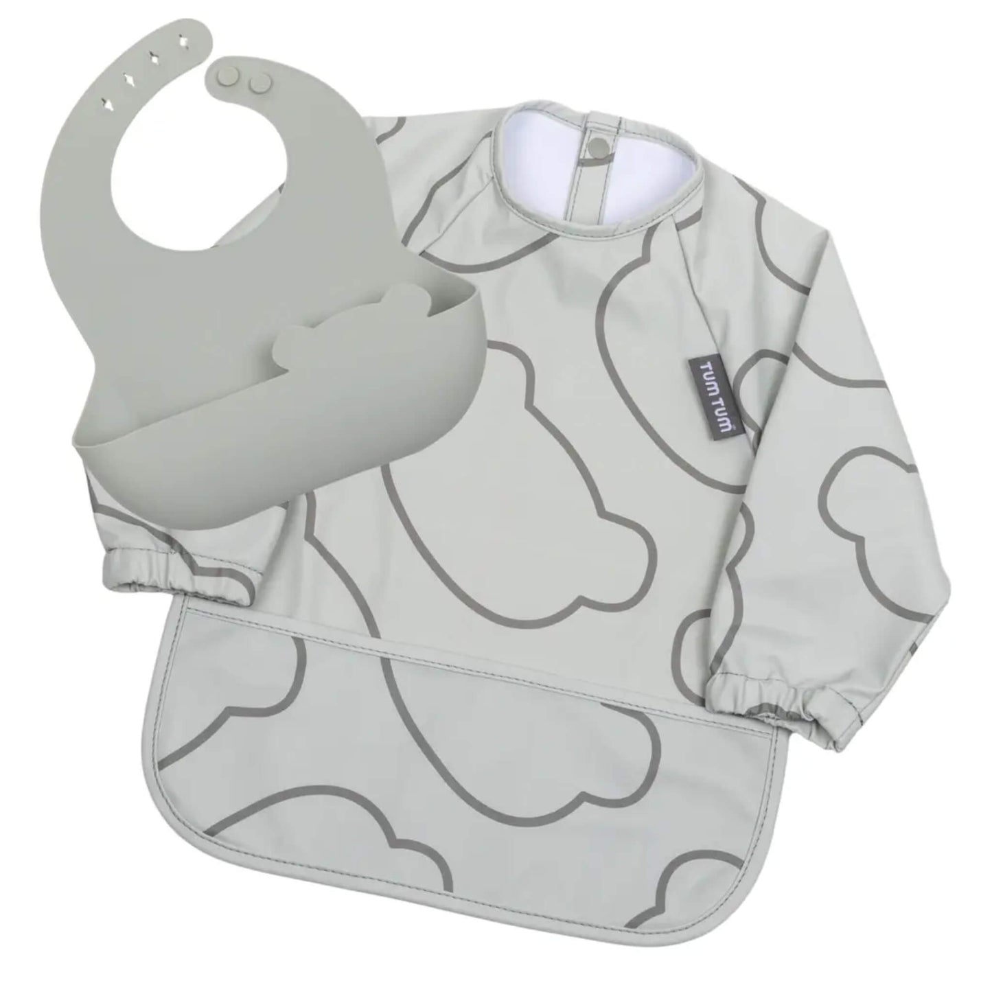 A grey TUM TUM Double Up Bib set laid flat, with a long-sleeved cloud-print coverall bib beneath a removable silicone bib with a deep bear-shaped pocket.
