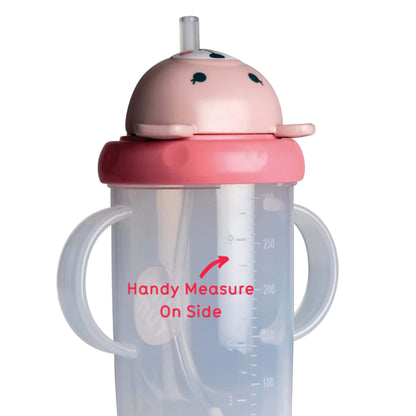 Close-up of a clear sippy cup with printed 200ml measurement markings visible on the side.