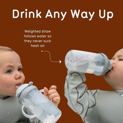 Two toddlers drinking at different angles as the weighted straw follows the water.
