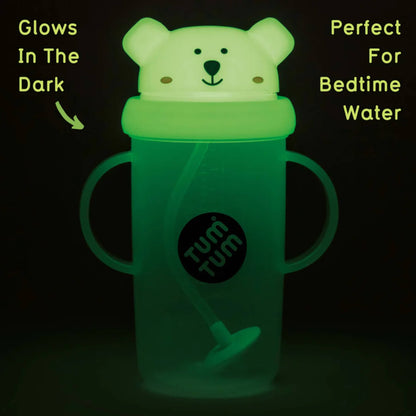 Glow-in-the-dark Pete Polar Bear sippy cup illuminated in low light, showing the lid and handles glowing softly for night-time visibility.