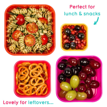 Four square plastic containers in red, yellow, orange, and pink, shown filled with different foods on a white background: pasta salad, olives, pretzels, and grapes. Text reads 'Perfect for lunch & snacks' and 'Lovely for leftovers.