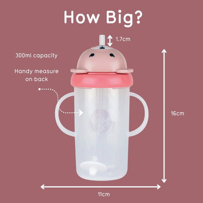 A baby tumbler with a pink animal-shaped lid and clear body, shown on a dusty rose background with measurement arrows and text reading 'How Big?' and dimensions 11cm, 16cm, and 1.7cm.