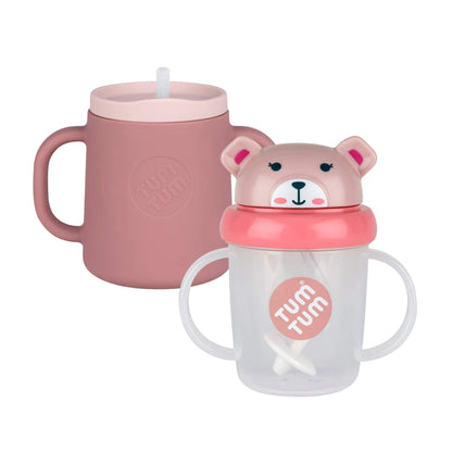 Tum Tum Tippy Up Cup and Trainer Cup bundle in the Betsy Bear design, showing a pink silicone trainer cup alongside a clear sippy cup with a bear lid and side handles.