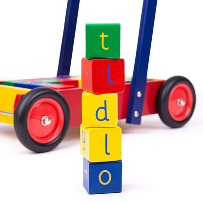 A stack of five colourful wooden blocks spelling “tidlo” in lowercase letters, placed in front of the baby walker.