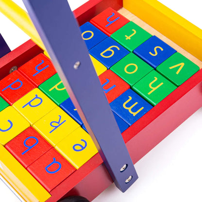 Overhead view of the walker showing the full grid of colourful letter blocks beneath the yellow and green handle bars.