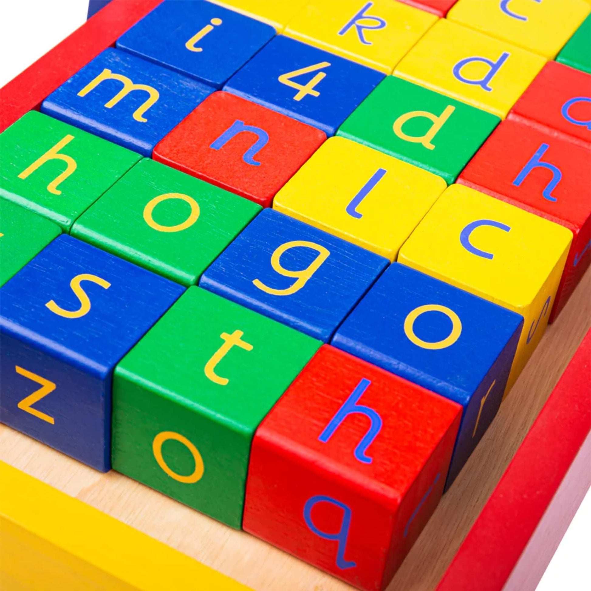 Overhead shot focusing on the varied colours and characters on the blocks, including letters like “h”, “g”, “t” and “a”.