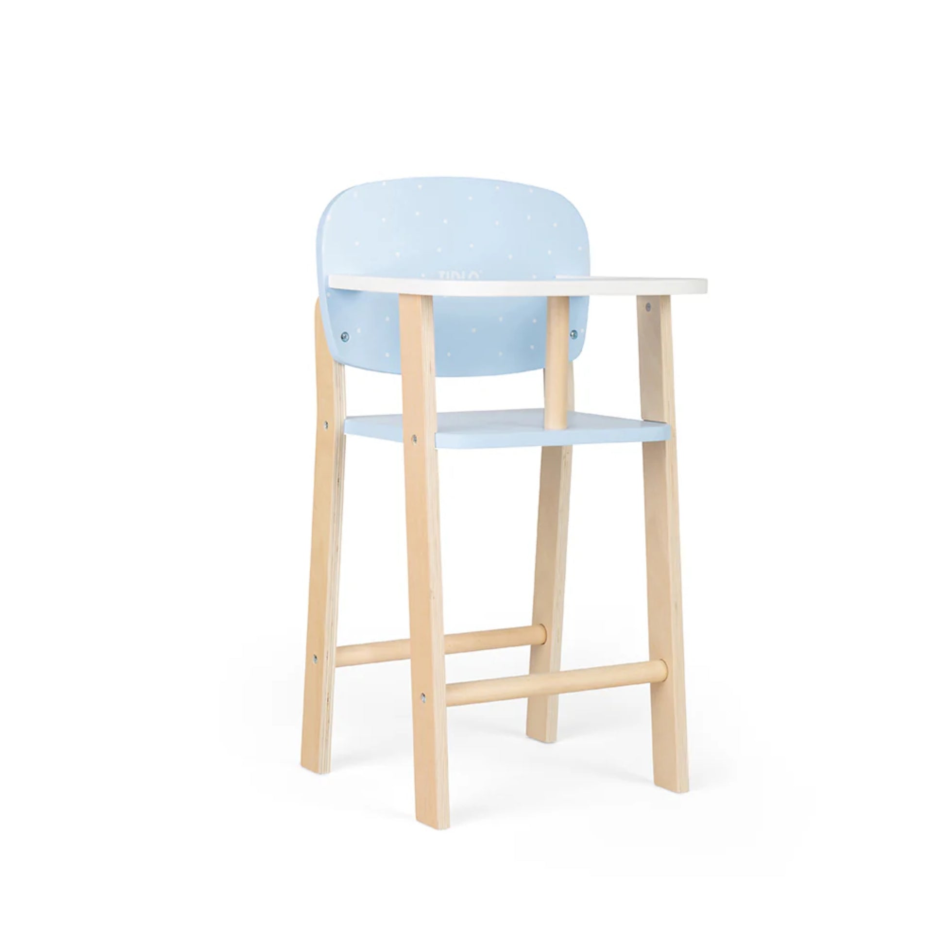 Side angle of the wooden doll’s highchair showing curved tray and smooth blue backrest with polka dots.