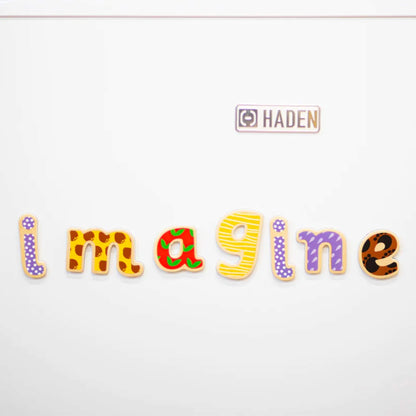 Close up of the word 'Imagine' spelt using wooden magentic letters placed against a white background.