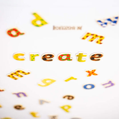 Colourful wooden letters on a white background with 'create' spelled out.