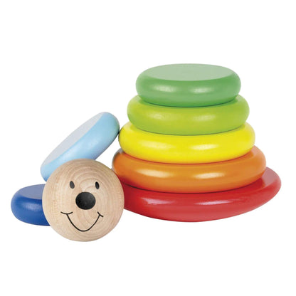 Disassembled wooden stacker toy with smiling face and seven colourful flat rings laid beside a red curved base, ready for stacking play.