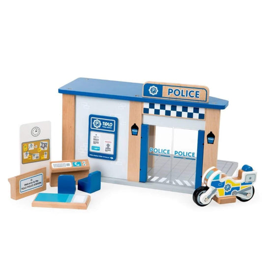 Tidlo Police Station wooden play set with blue roof, front signage and accessories including a desk, bike, line-up board, seating and cell bed.