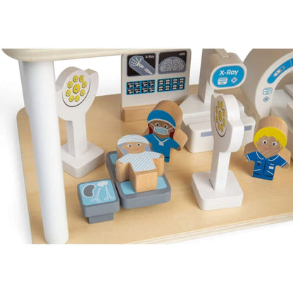A wooden toy hospital playset with small character figures, medical equipment, and a light wood base on a white background.