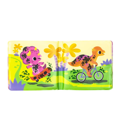 Open page from the bath book showing a pink triceratops on a skateboard and an orange dinosaur on a bike, both covered in dark muddy spots.