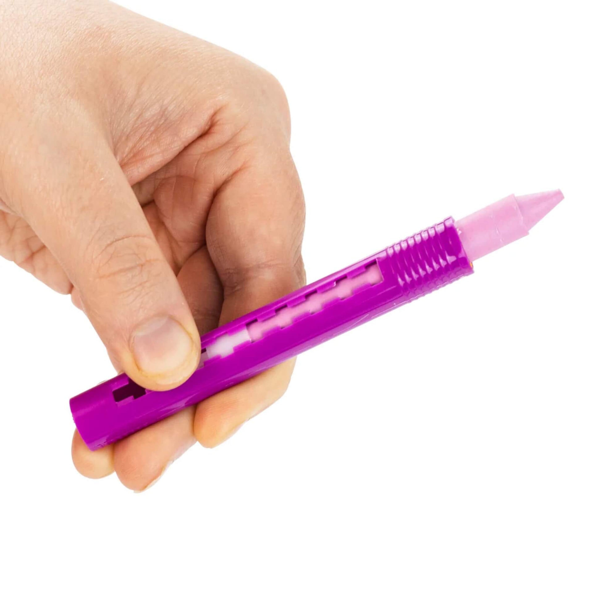 Close-up of a hand holding a pink Tiger Tribe bath crayon with twist-up casing, showing the crayon tip.