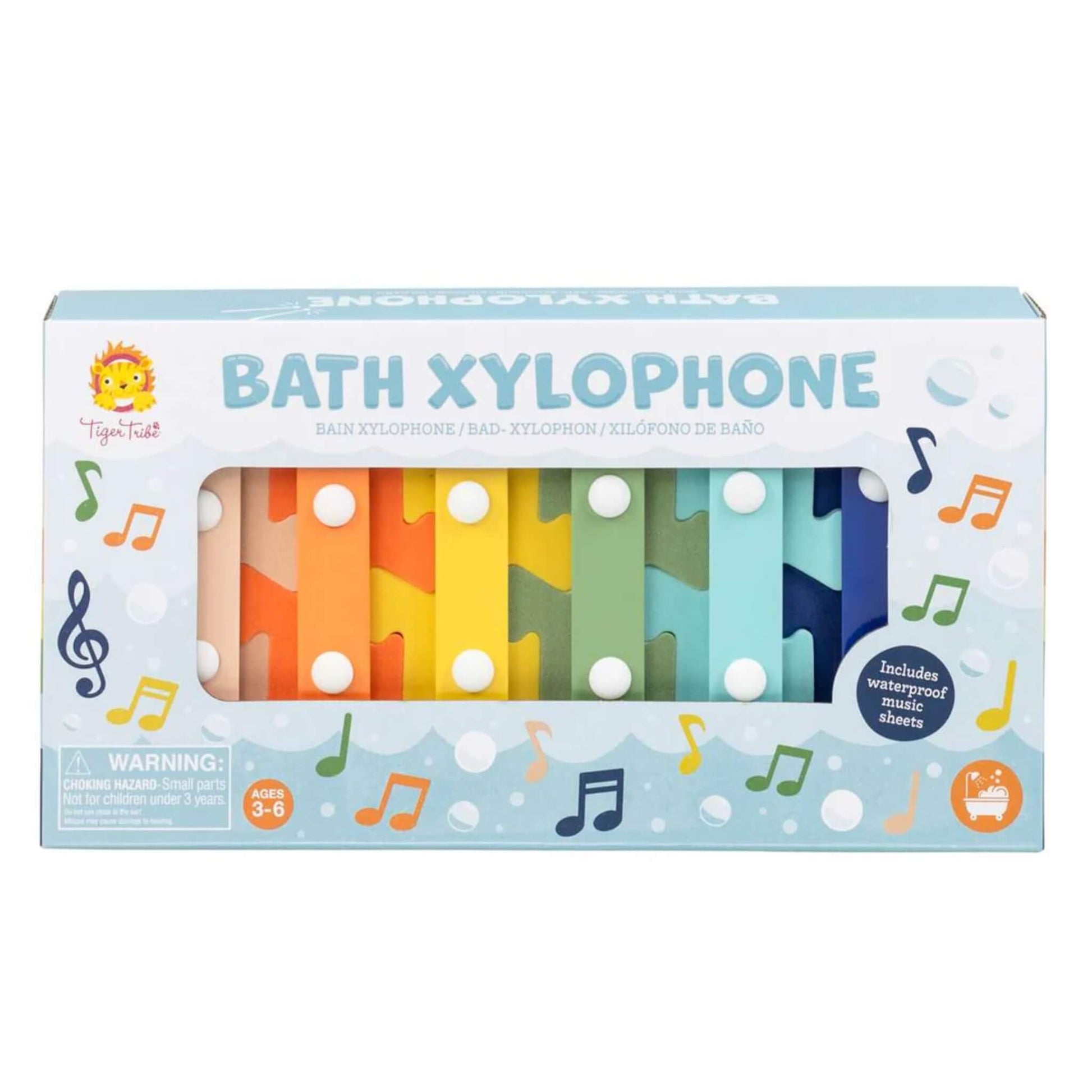 Tiger Tribe Bath Xylophone displayed in packaging with six rainbow-coloured keys visible and a “Includes waterproof music sheets” label.