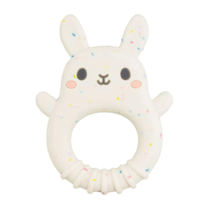 A speckled white Tiger Tribe bunny-shaped teether with a rounded base and ring grip, featuring blushing cheeks and upright ears.
