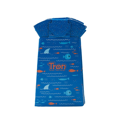 Folded Tron potty in blue fish print, showing compact flat-pack design with the brand name on the front.