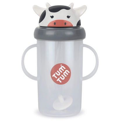 A translucent plastic sippy cup with two handles, a grey lid, and a cow-shaped top spout. The cup has a red circular logo on the front that reads 'TUM TUM'.