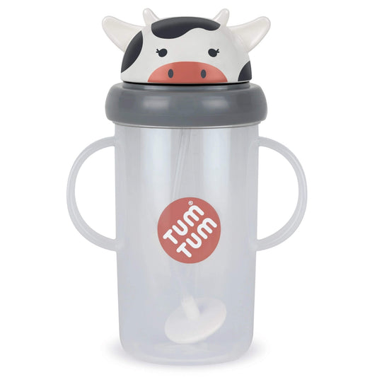 A translucent plastic sippy cup with two handles, a grey lid, and a cow-shaped top spout. The cup has a red circular logo on the front that reads 'TUM TUM'.