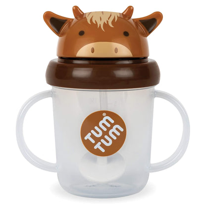 A clear plastic sippy cup with a cow-themed lid, featuring a brown and tan cow face with a dark brown band. The cup has built-in handles and a visible straw, with a circular brown 'TUM TUM' logo on the front, set against a plain white background.