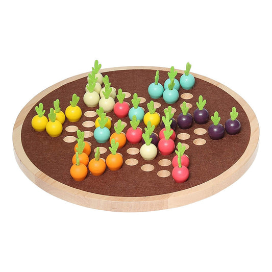 A round wooden board game with colourful vegetable-shaped pieces in various starting positions on a brown playing surface with drilled holes.
