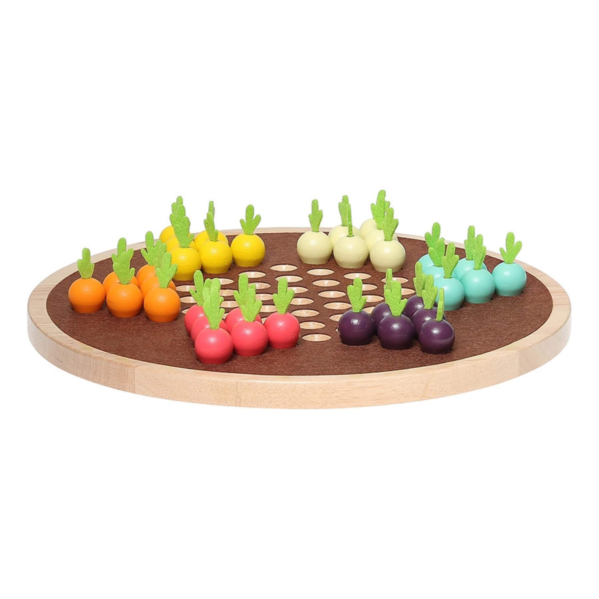A wooden board game viewed from the side, featuring brightly coloured vegetable-shaped pieces in six colour groups arranged for play.