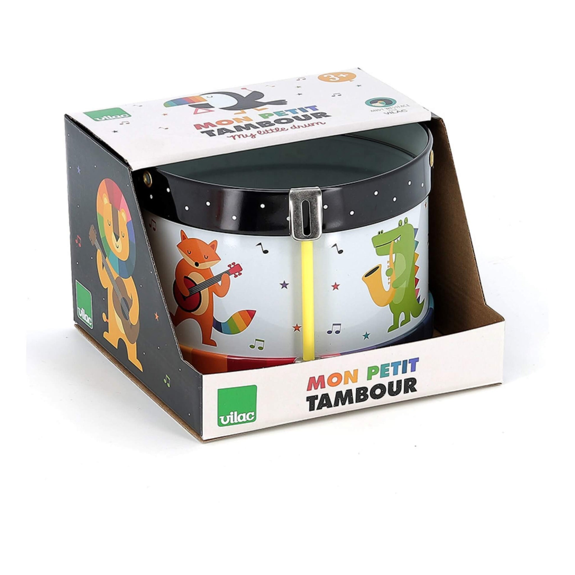A packaged metal toy drum in an open-front cardboard box, showing animal illustrations including a fox playing guitar and a crocodile playing saxophone.