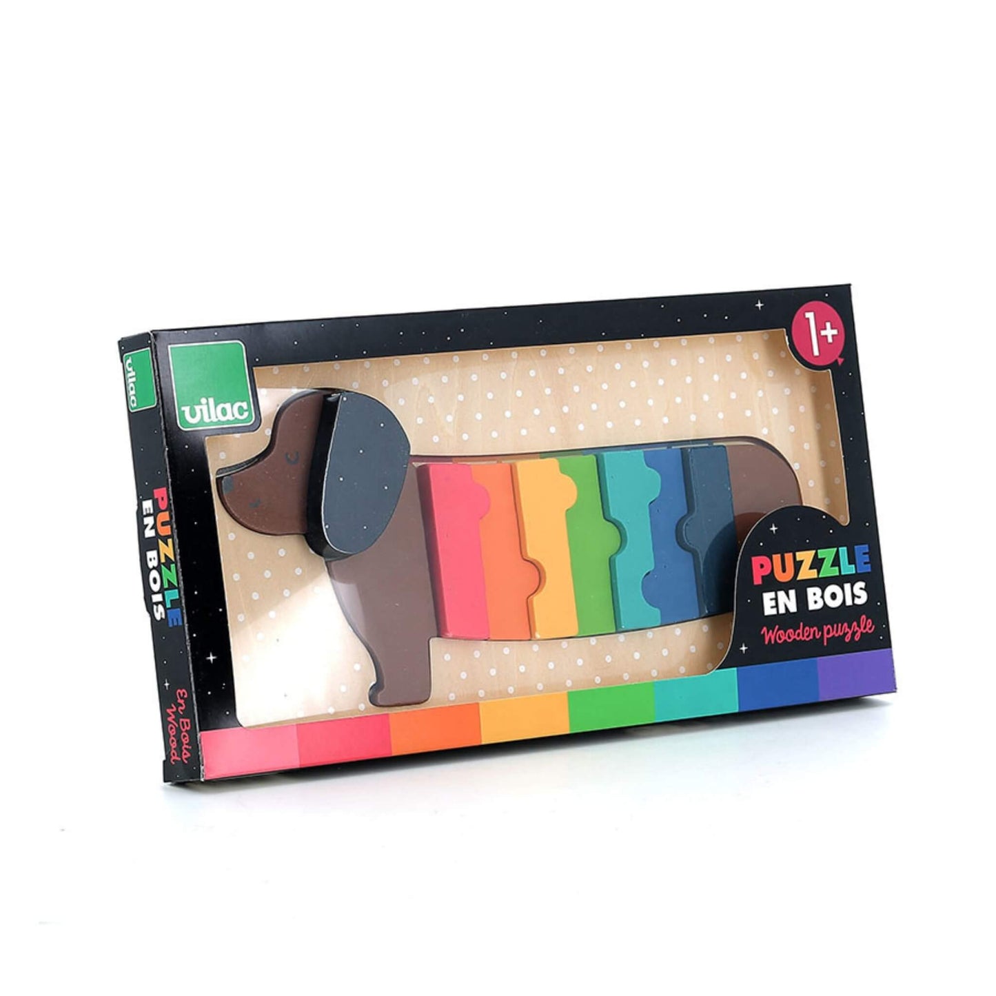 A boxed wooden dachshund puzzle photographed from an angle, showing the assembled dog through the packaging window.