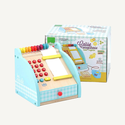 A wooden toy cash register placed in front of its box, showing keypad buttons, bead abacus, receipt roll, and closed drawer.