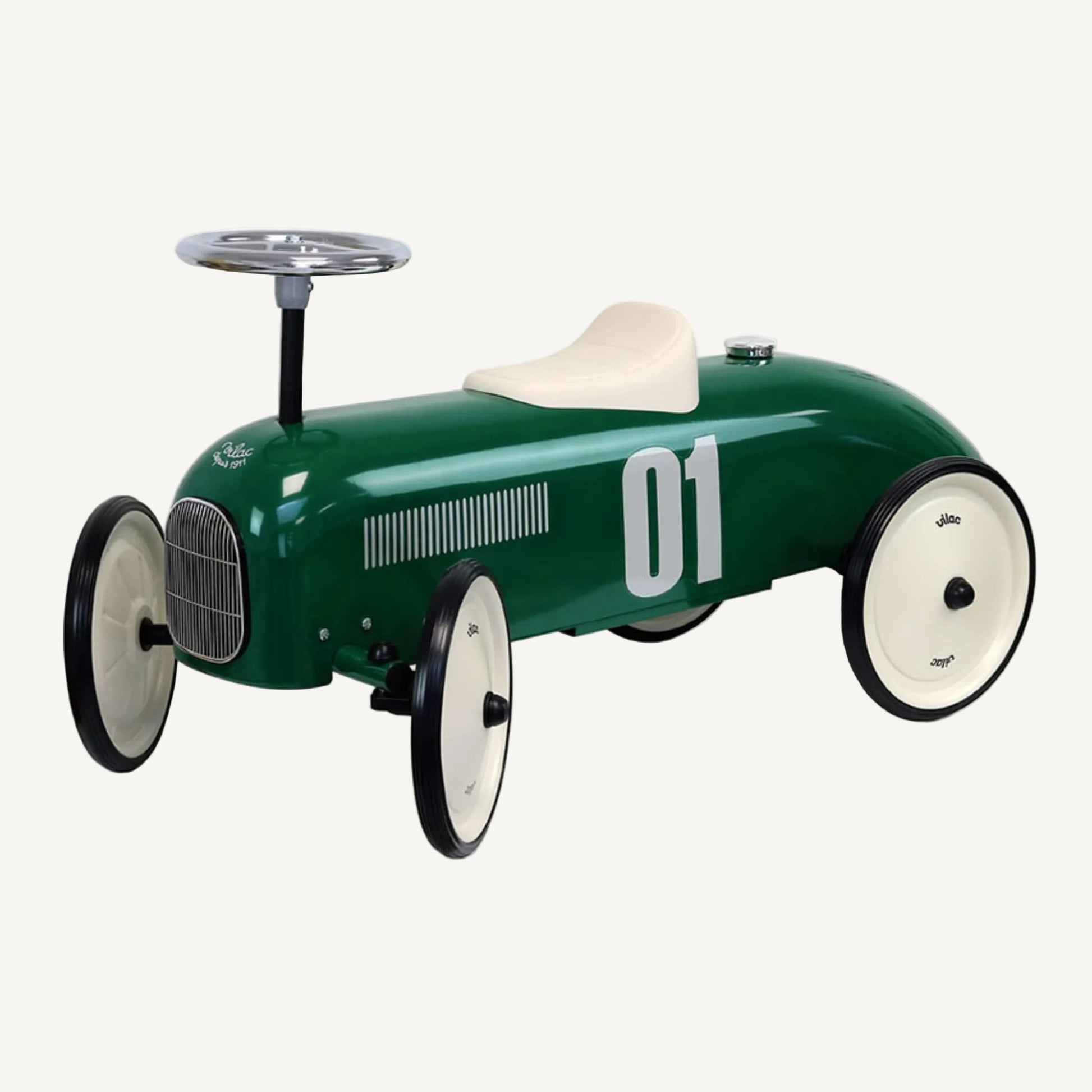 A vintage style ride-on toy car in dark green with a cream seat, chrome steering wheel and four cream wheels with black tyres, shown against a plain background.