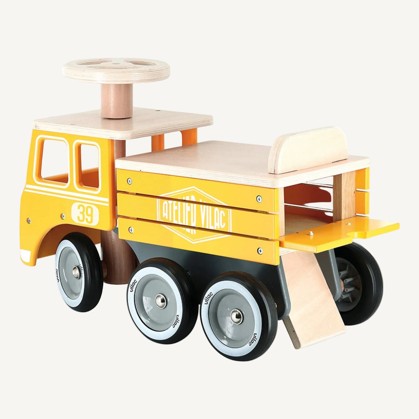 A wooden ride on truck toy shown from rear angle with open back storage compartment and ramp detail, six wheels and chunky steering wheel for toddlers.