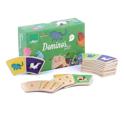 A  kids dominoes set, featuring a green box and 28 wooden domino tiles illustrated with various farm animals and vegetables.