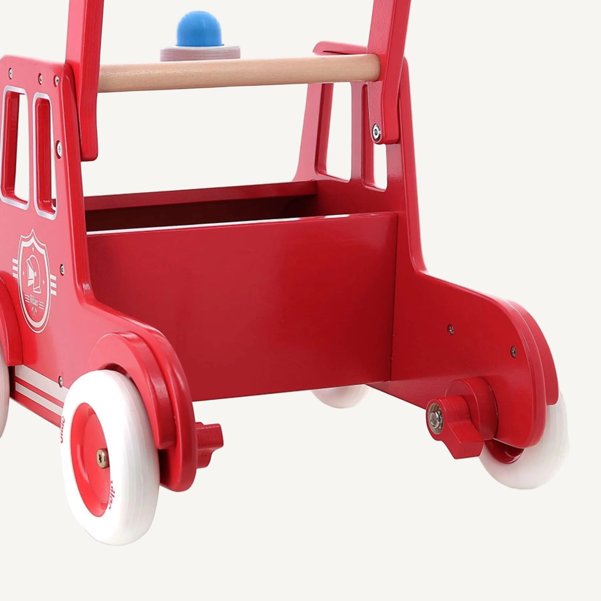 A close-up of a wooden fire engine walker showing internal storage compartment and wheel base with stable structure for early walking.