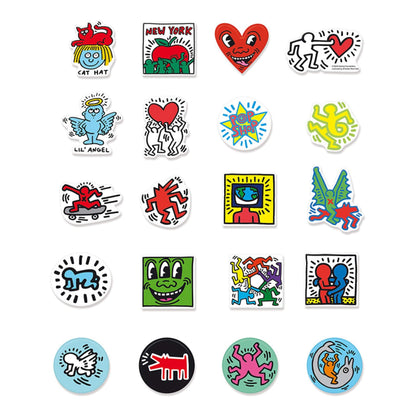 A set of 20 wooden magnets laid out showing Keith Haring’s iconic designs including dancing figures, hearts, dogs, and abstract shapes.