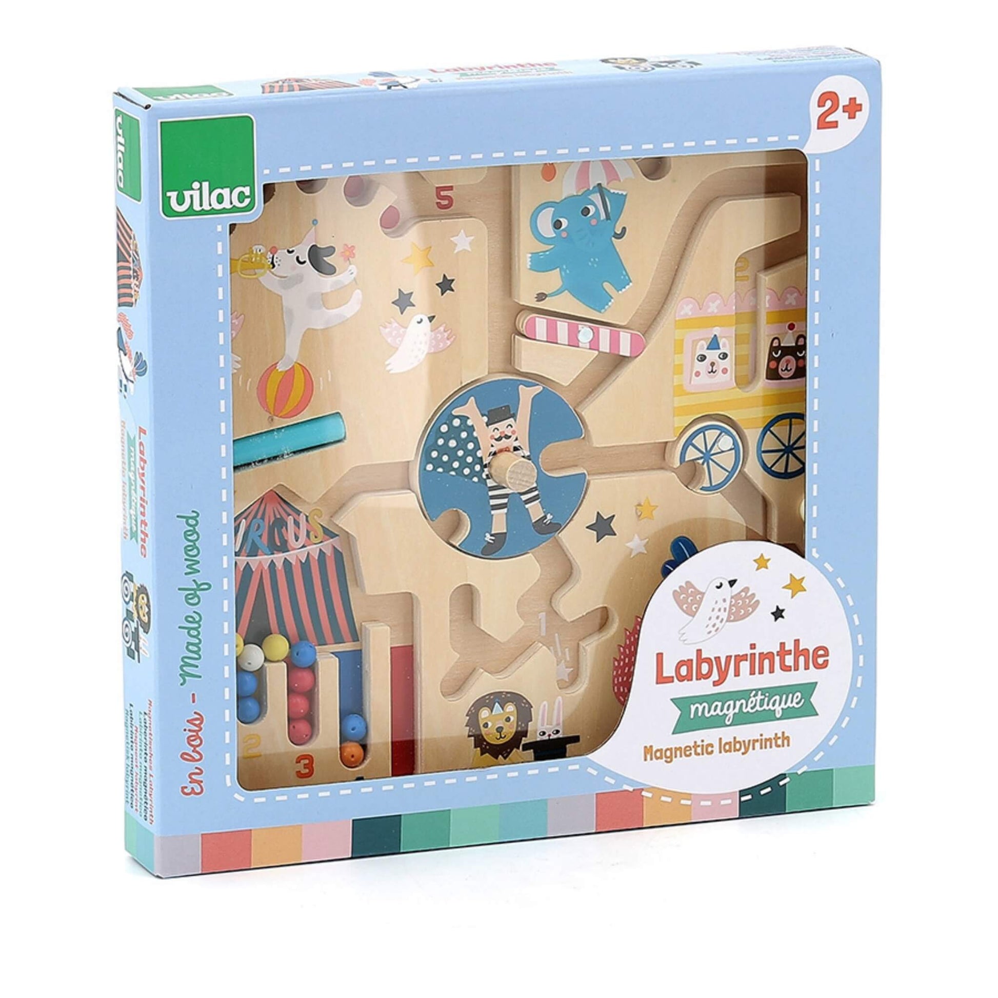 Front of a wooden magnetic maze with circus theme, showing animals, performers and beads on winding tracks, packaged in a blue Vilac box marked Labyrinthe Magnétique.