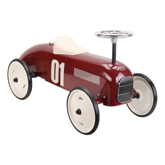 Side angled view of a burgundy metal ride-on toy car with white seat, chrome steering wheel and number 01 decal on the side.