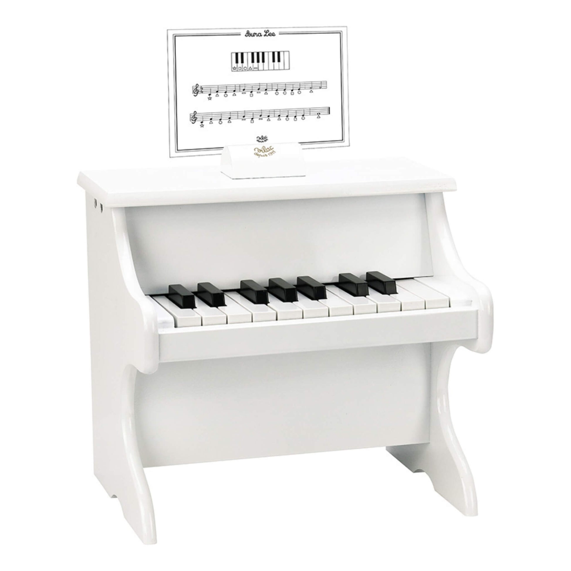 Small white wooden upright toy piano with black and white keys and a simple music score card placed on the holder.
