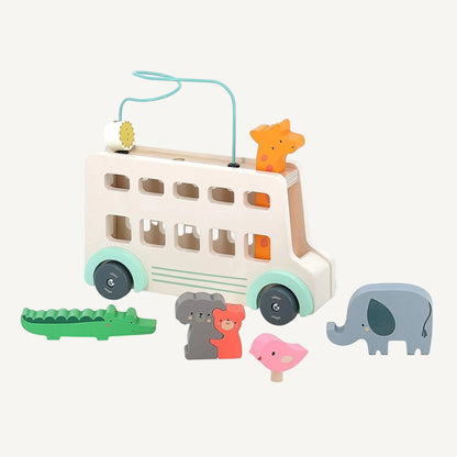 Pastel wooden bus activity toy with removable animal pieces including crocodile, elephant and bird.
