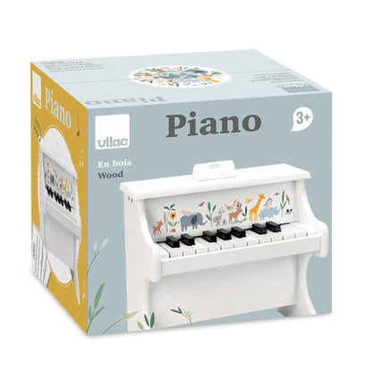 Vilac piano box featuring a white wooden toy piano with animal illustrations and a 3+ age recommendation.
