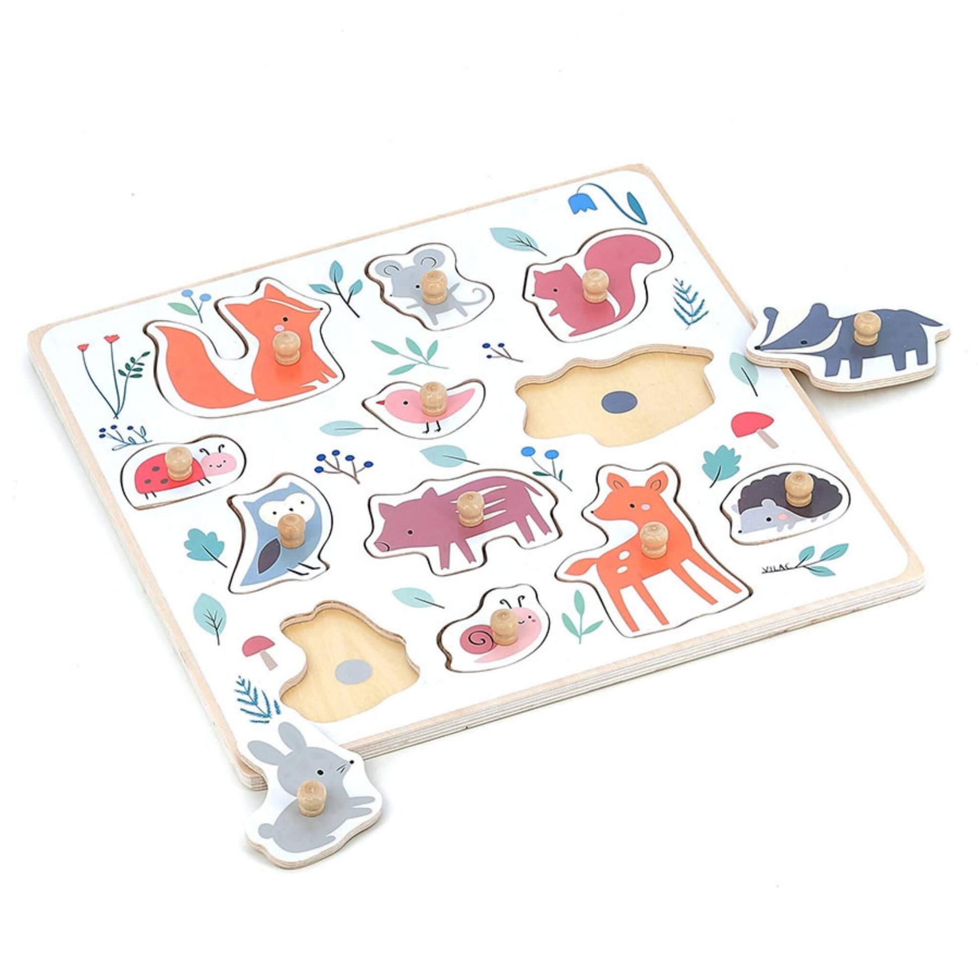 Forest animal puzzle with wooden peg pieces removed, showing cut-out shapes for matching play.