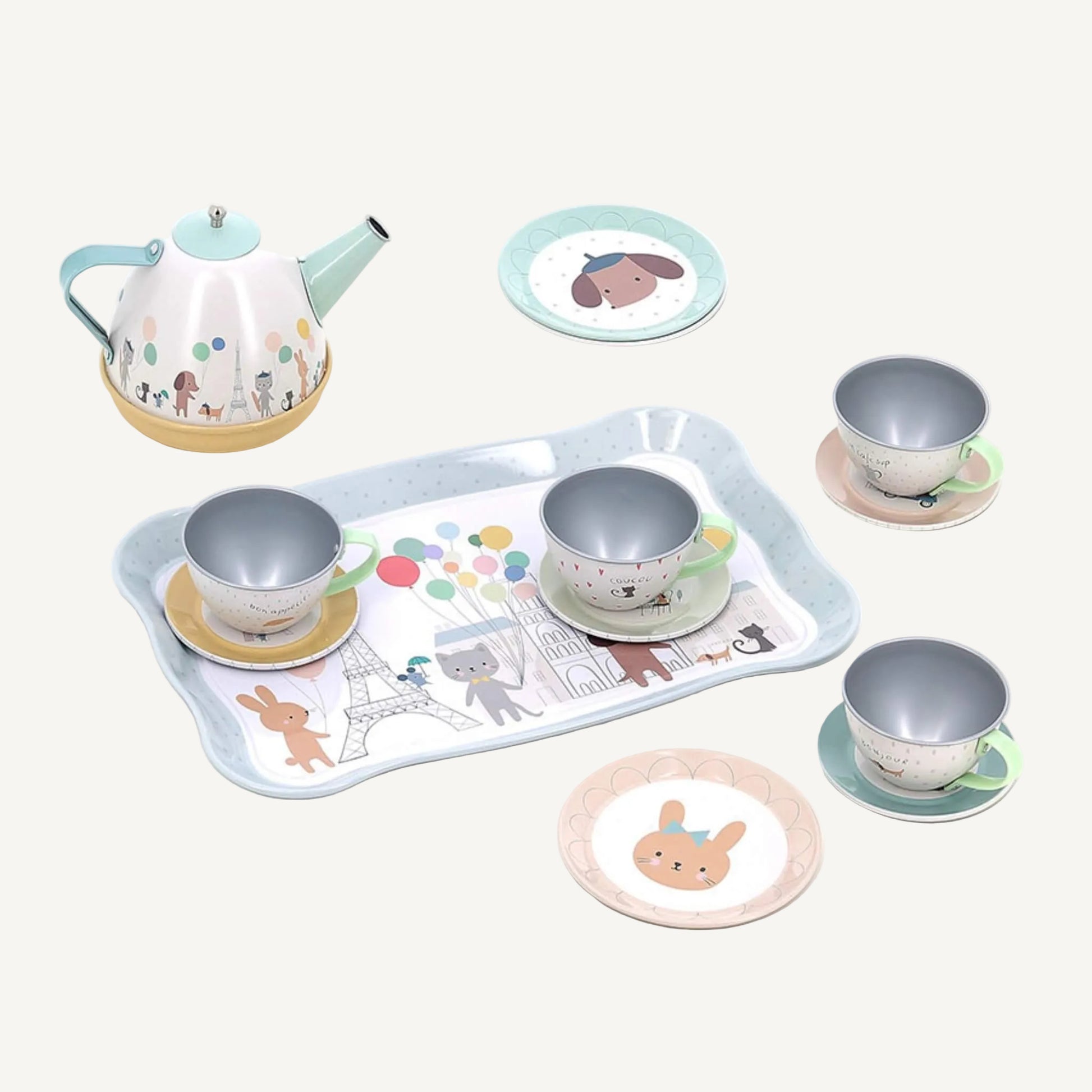 Musical toy tea set with illustrated teapot, cups, saucers and serving tray arranged on a white background.