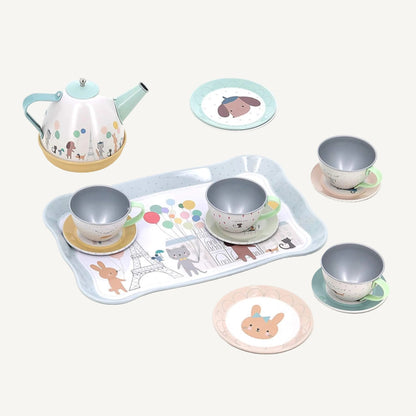 Musical toy tea set with illustrated teapot, cups, saucers and serving tray arranged on a white background.