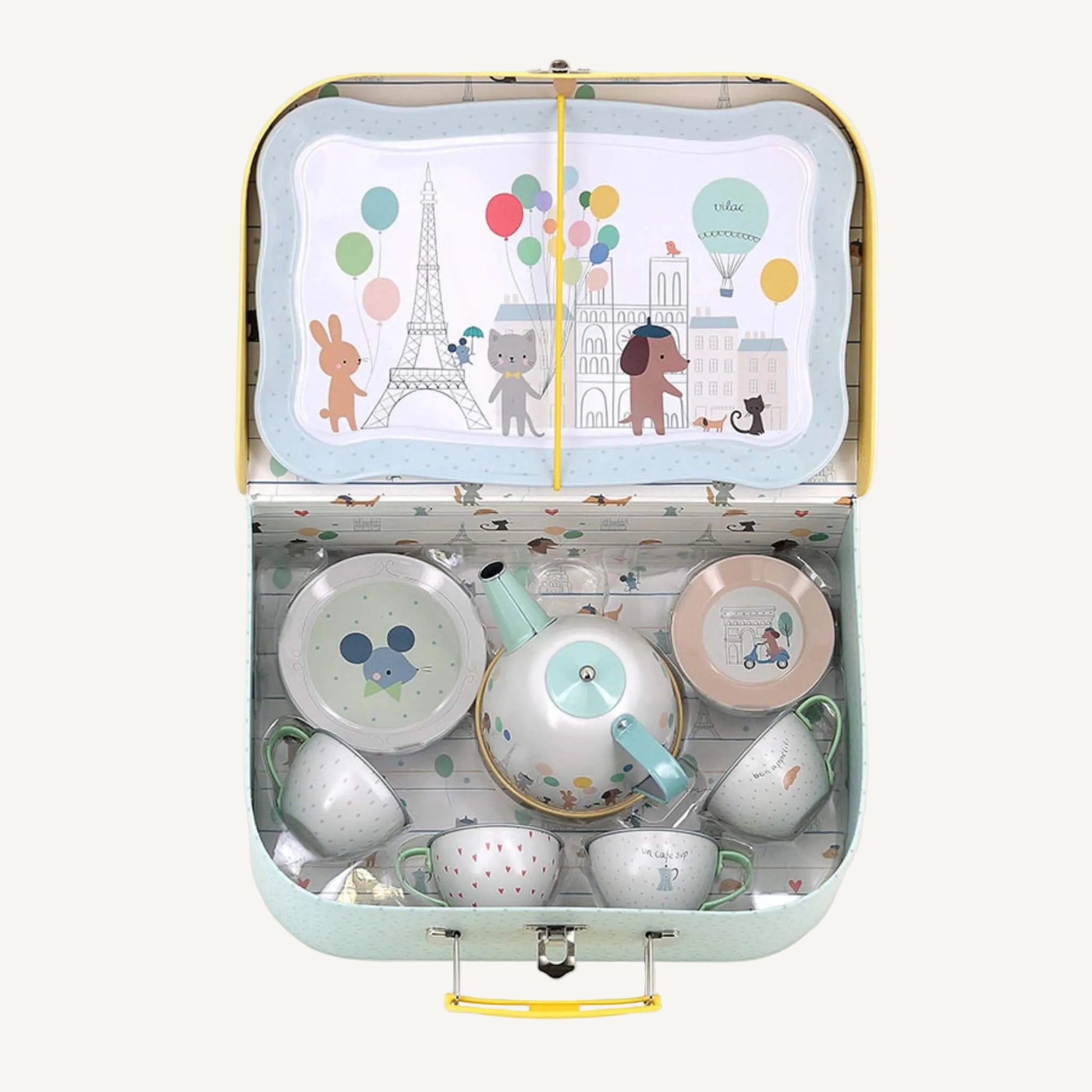Open tin toy tea set suitcase with metal teapot, cups, saucers and illustrated serving tray inside.